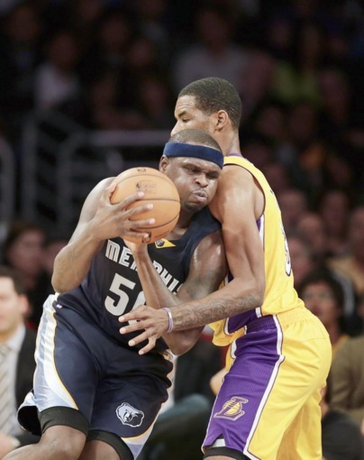 Memphis Grizzlies forward Zach Randolph, left, tries to muscle past Lakers forward Shawne Williams in a Nov. 15 game at Staples Center.