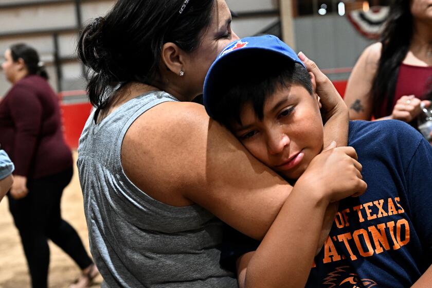 Uvalde, Texas May 25, 2022- Adrian Alonzo is consoled by his mother during a vigil Wednesday at the Uvalde County Fairplex to honor the fallen victims of a mass shooting in Texas. Nineteen students and two teachers died when a gunman opened fire in a classroom yesterday. (Wally Skalij/Los Angeles Times)