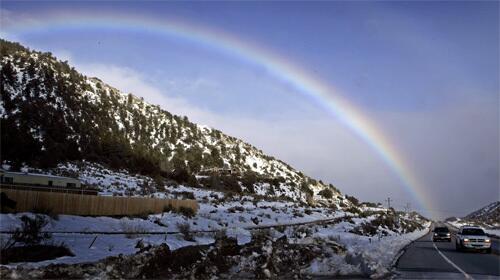 A break in the storm allowed a rainbow to form in snow covered Frazier Park.