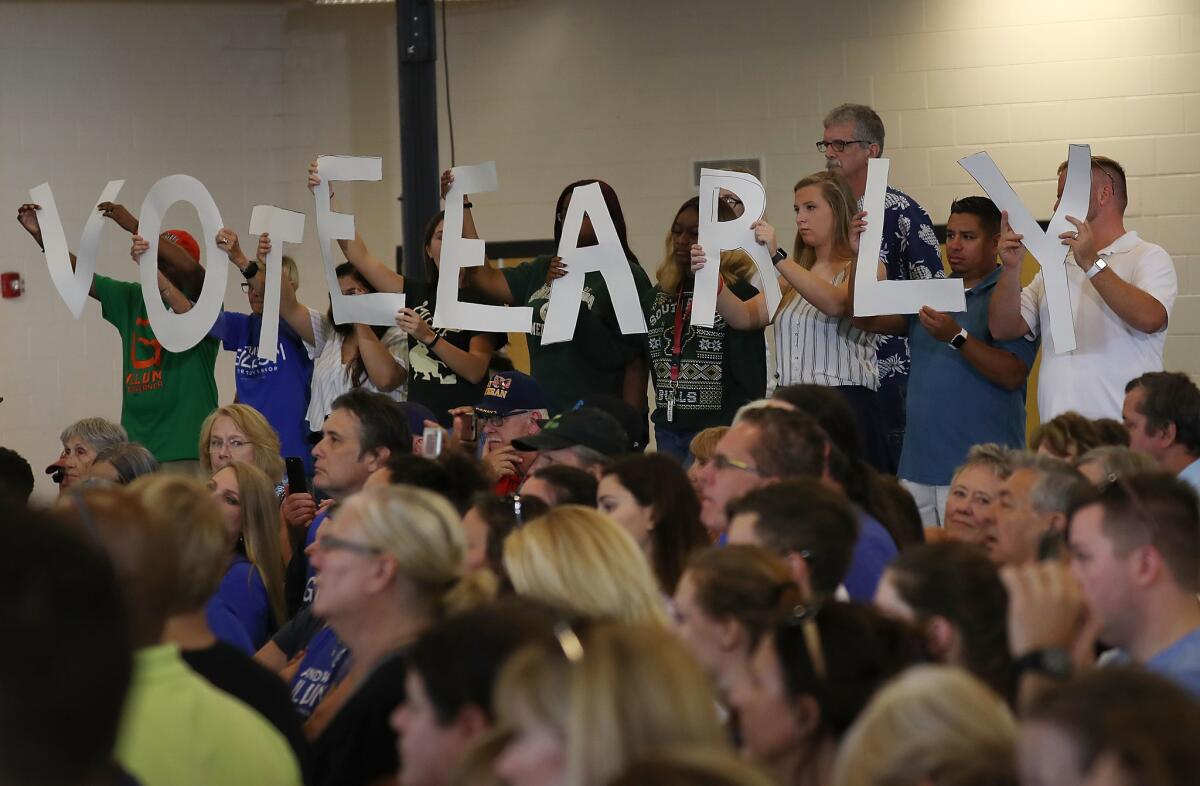 Attendees spell out 'vote early' at a rally for Democratic candidates Monday at the University of South Florida in Tampa.
