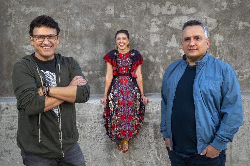 LOS ANGELES, CA - NOVEMBER 25, 2020: Left to right-Anthony Russo, his sister, Angela Russo-Otstot, and brother Joe Russo are photographed outside AGBO Studios in Los Angeles. The Russo brothers directed the movie, Cherry, with the script being co-adapted by their sister Angela. (Mel Melcon / Los Angeles Times)