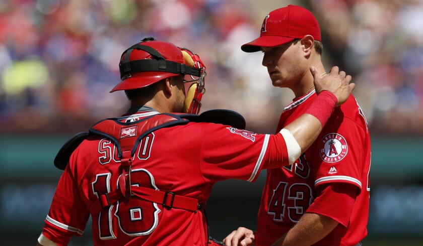 Angels catcher Geovany Soto, left, meets pitcher Garrett Richards on the mound for a conference during the fourth inning against the Texas Rangers on May 1.