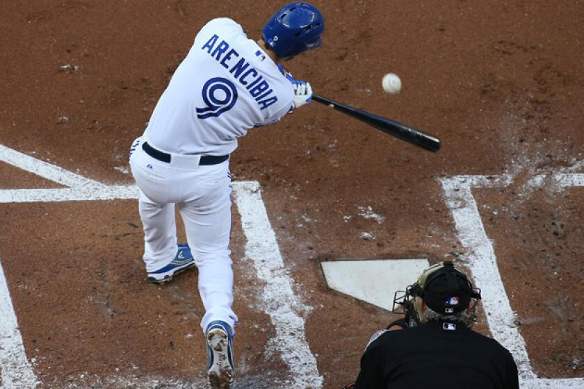 Toronto Blue Jays catcher J.P. Arencibia hits a run-scoring liner to center field against the San Francisco Giants.