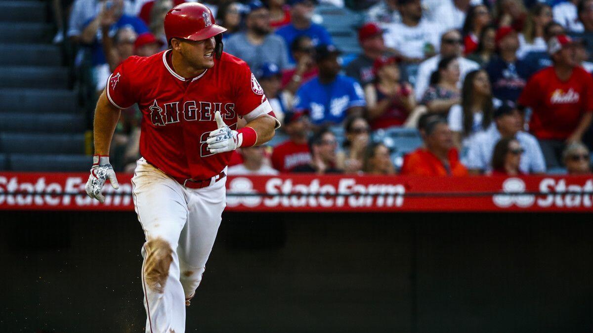 Angels center fielder Mike Trout hits a home run against the Dodgers on Saturday.