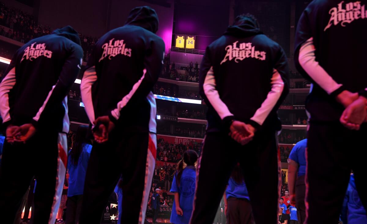 Kobe Bryant's jerseys hang as Clipper players prepare for their game with the Kings.