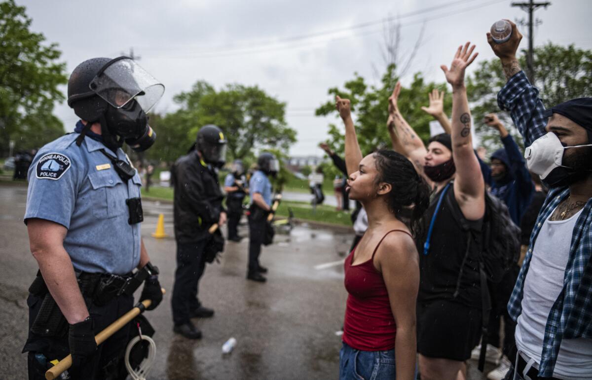 Demonstrators and Minneapolis police face each other May 26 during a protest after the death of George Floyd.