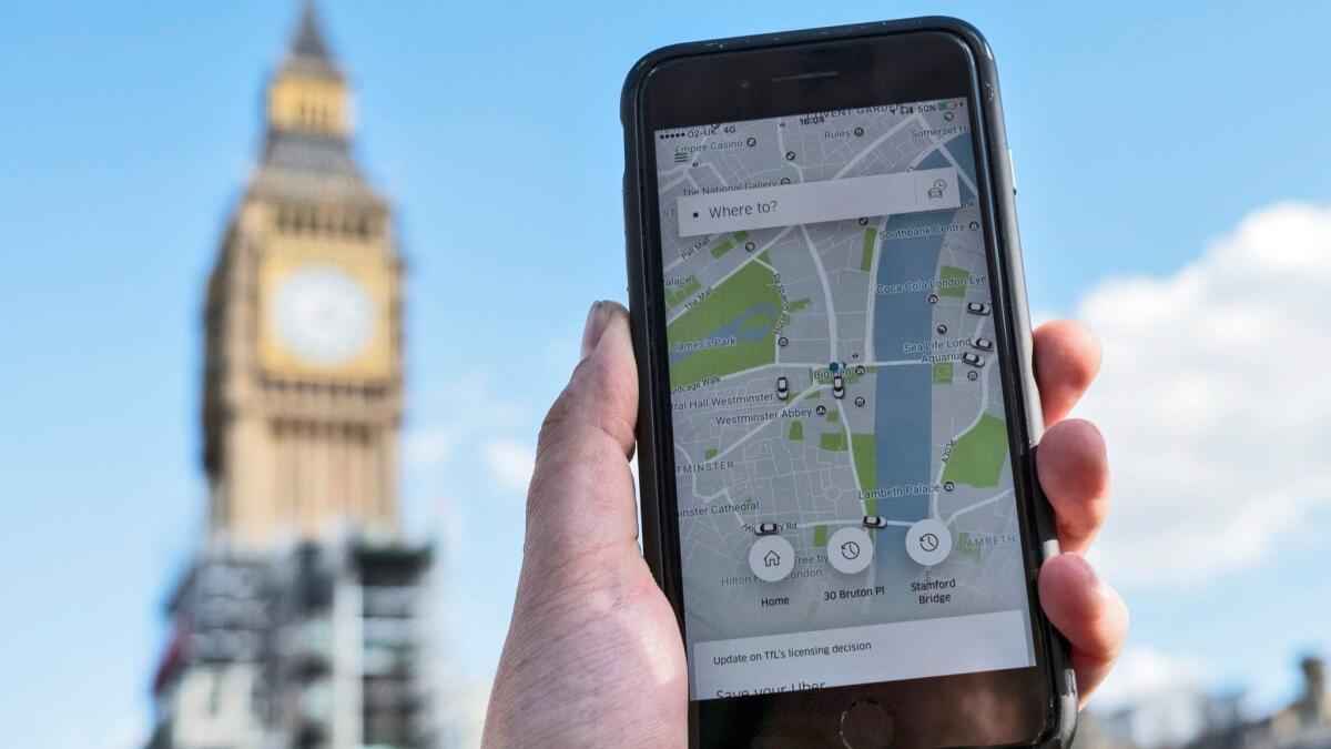 A phone shows the Uber app in central London.