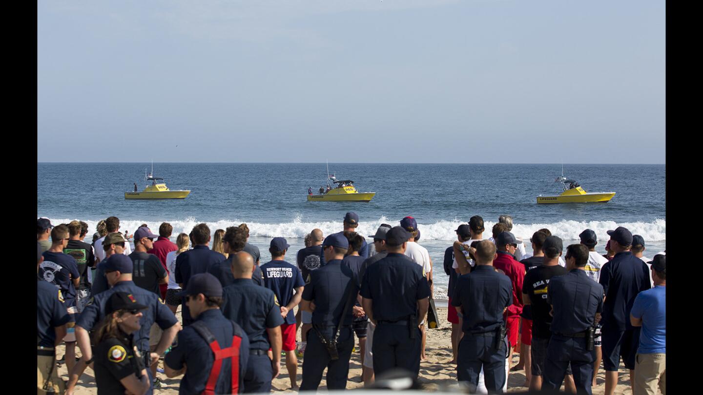 Three Newport Beach lifeguard rescue boats line up off the beach durng a ceremony at 16th Street to mark the three-year anniversary of the death of Ben Carlson on Thursday, July 6.