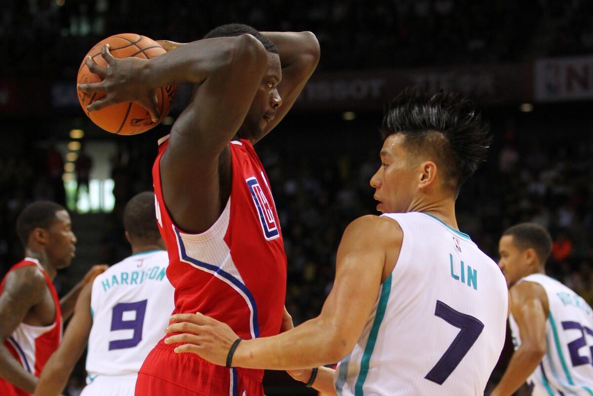 Clippers' Lance Stephenson looks to pass against Charlotte's Jeremy Lin in Shenzhen, China, on Saturday.