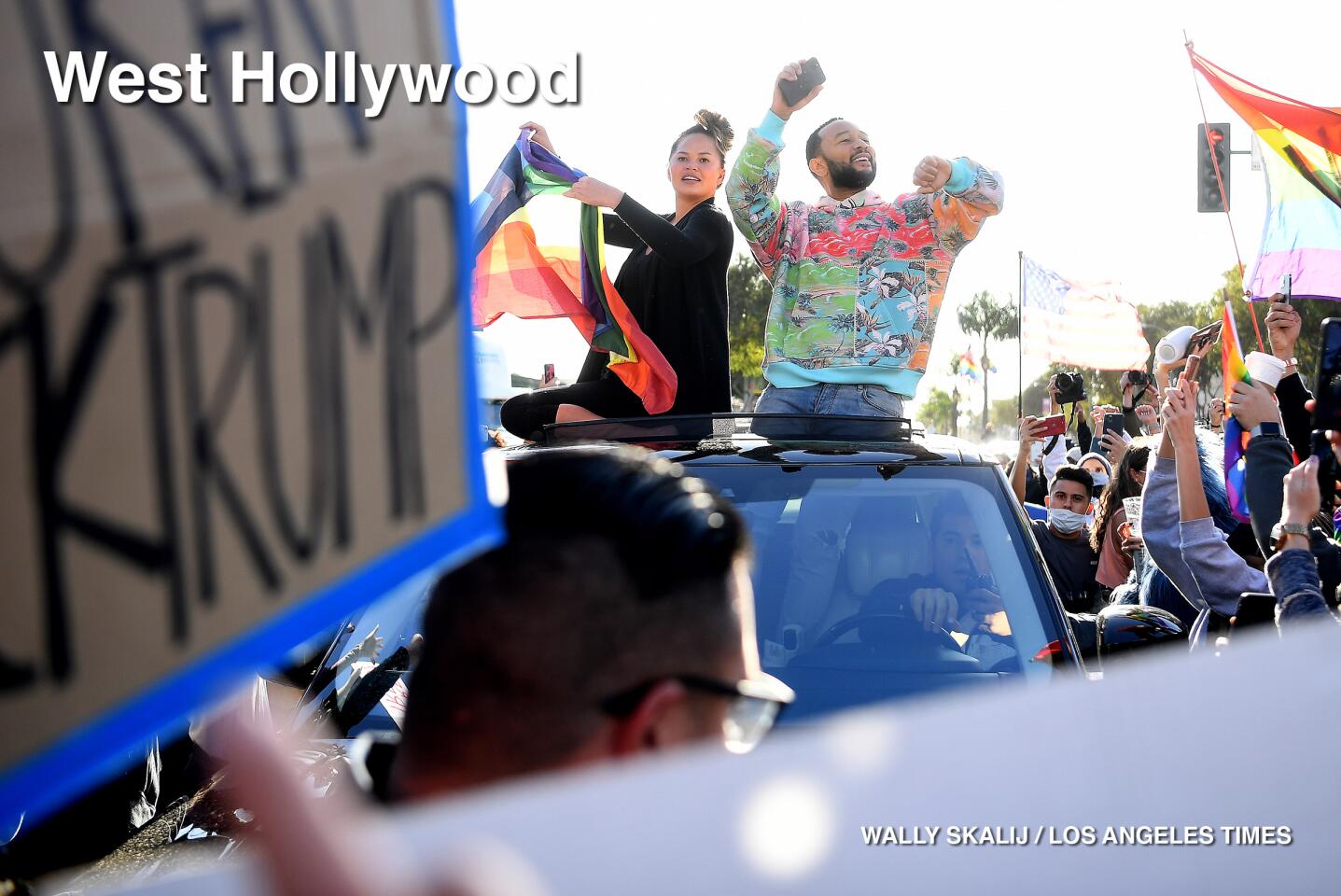 Singer John Legend and is wife Chrissy Teigen celebrate along Santa Monica Blvd. in West Hollywood.