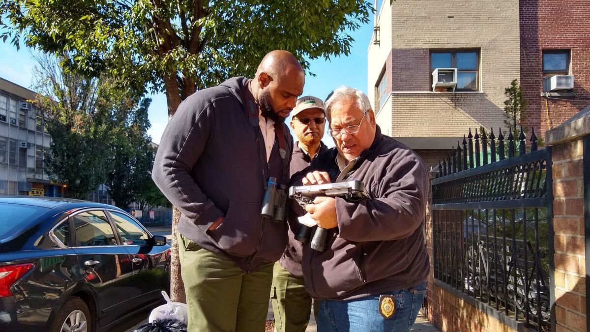 Ground surveyors Mohsen Abdelaziz, right, and Amir Ahmed, center, strategize with supervisor Antony Massop about how to get access to a "refusal" property in the Bedford-Stuyvesant section of Brooklyn.