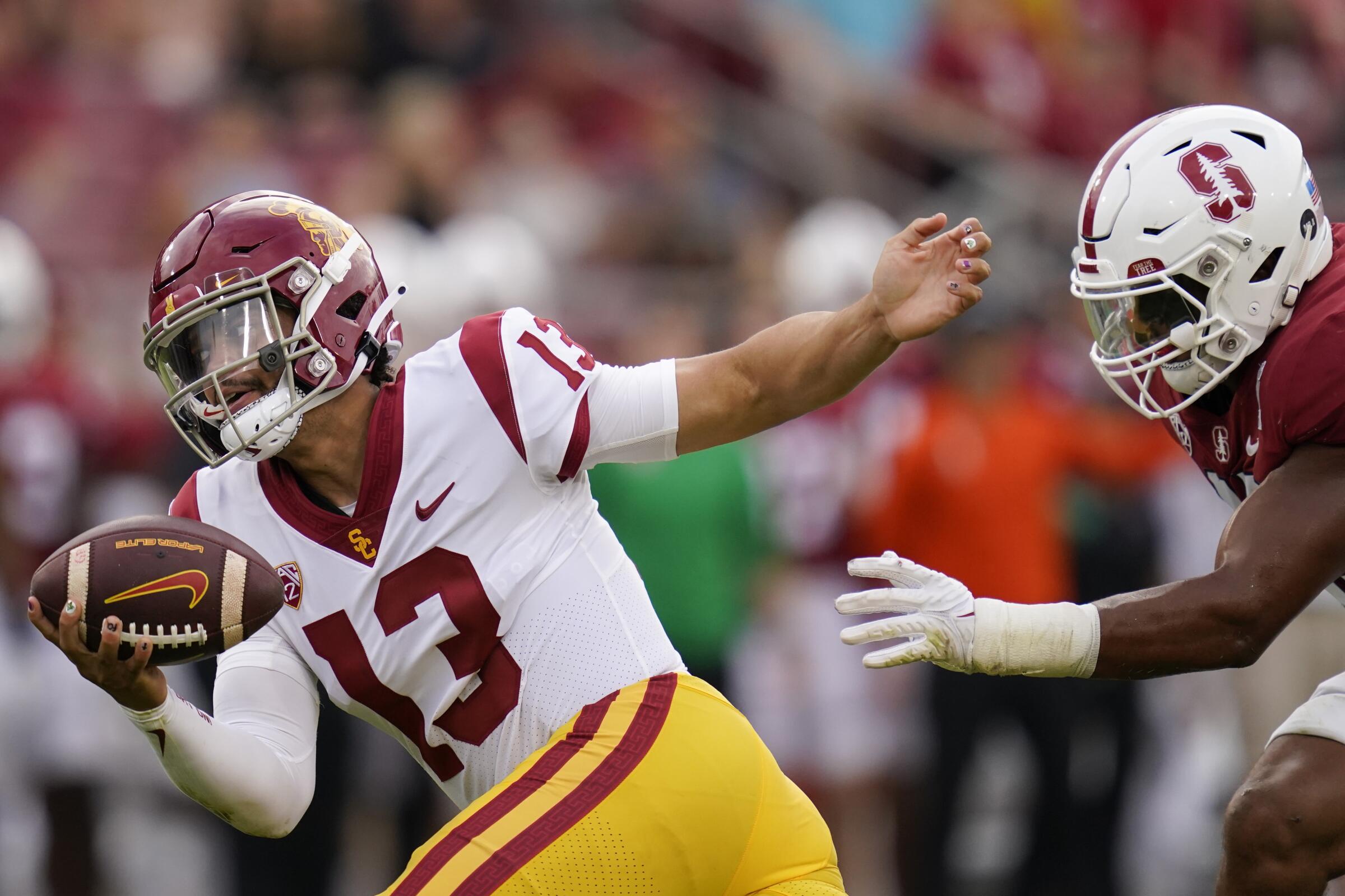 USC quarterback Caleb Williams tries to evade Stanford linebacker Ricky Miezan.