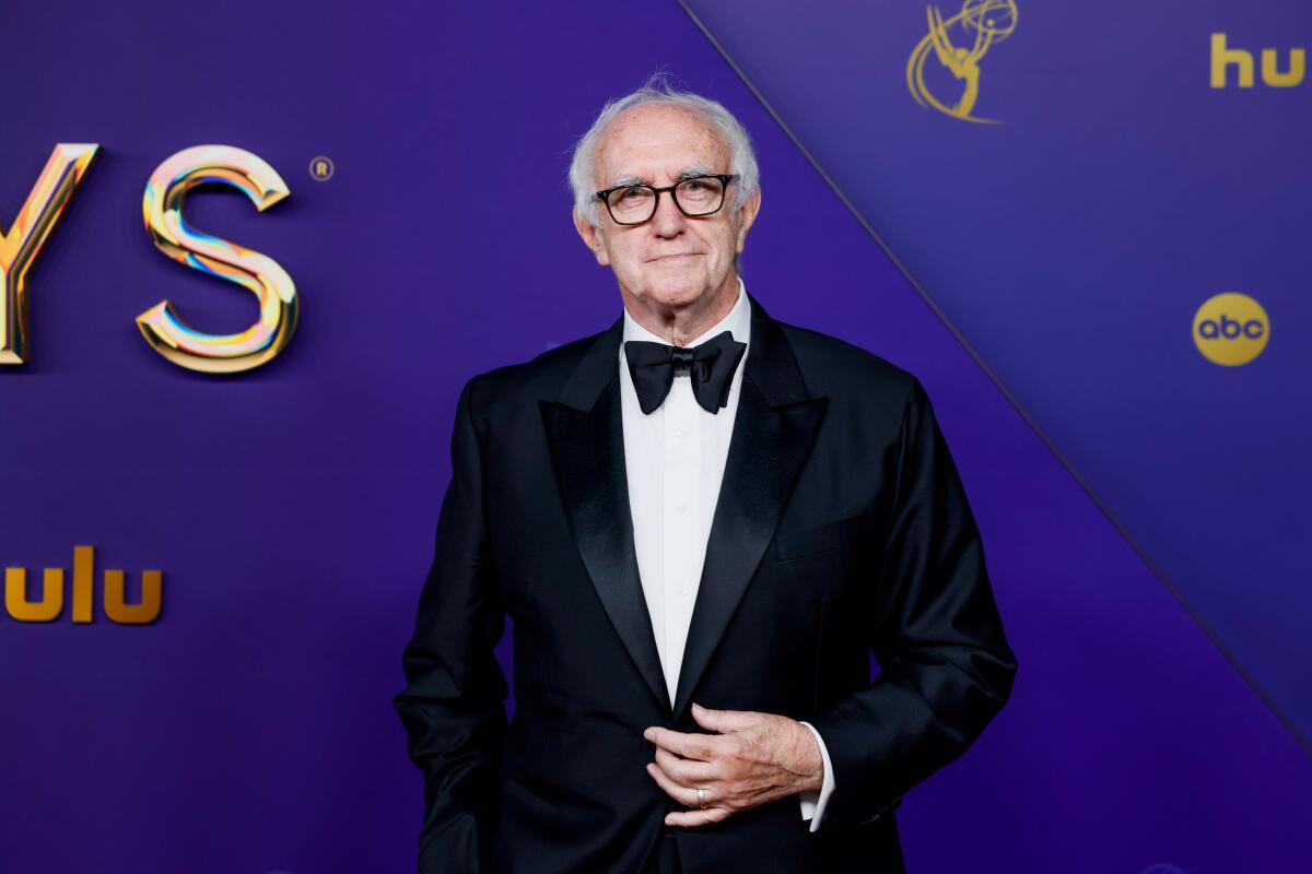 Jonathan Pryce smiles in a tux.