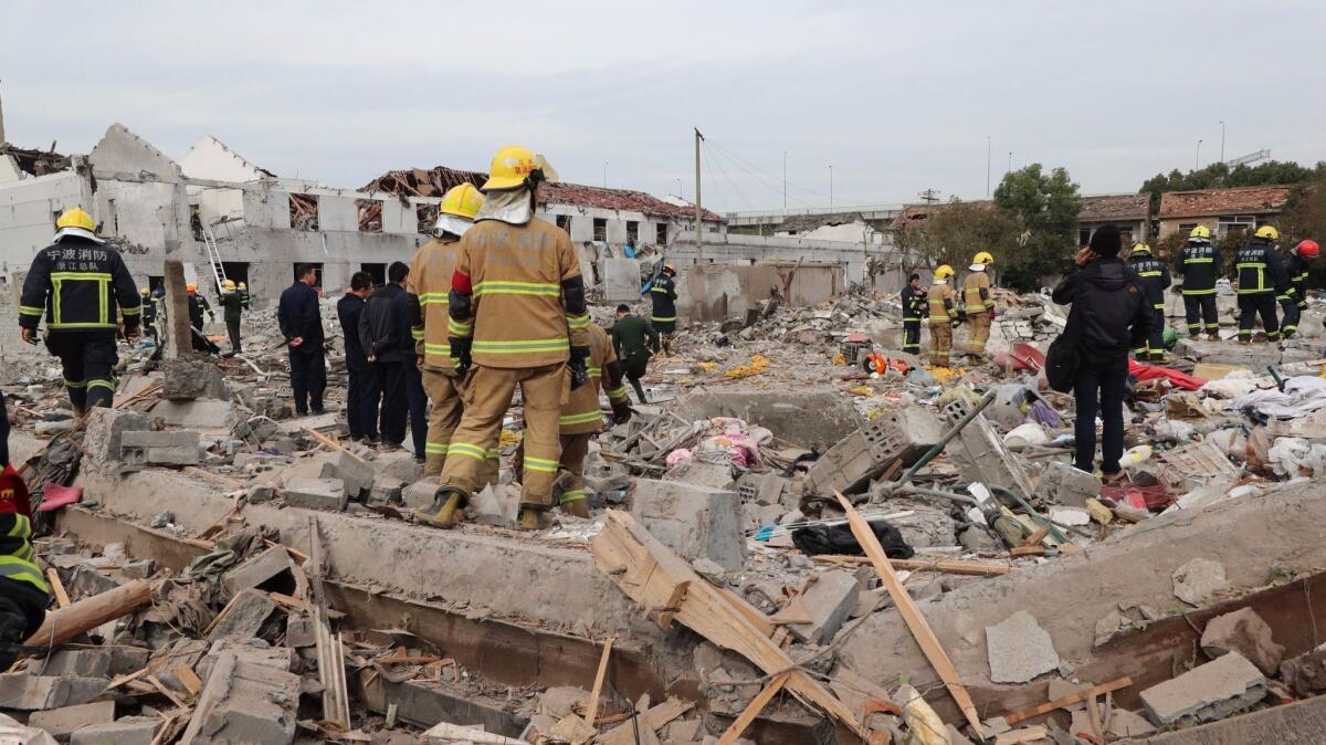 Rescue workers search the explosion site in Ningbo, China.