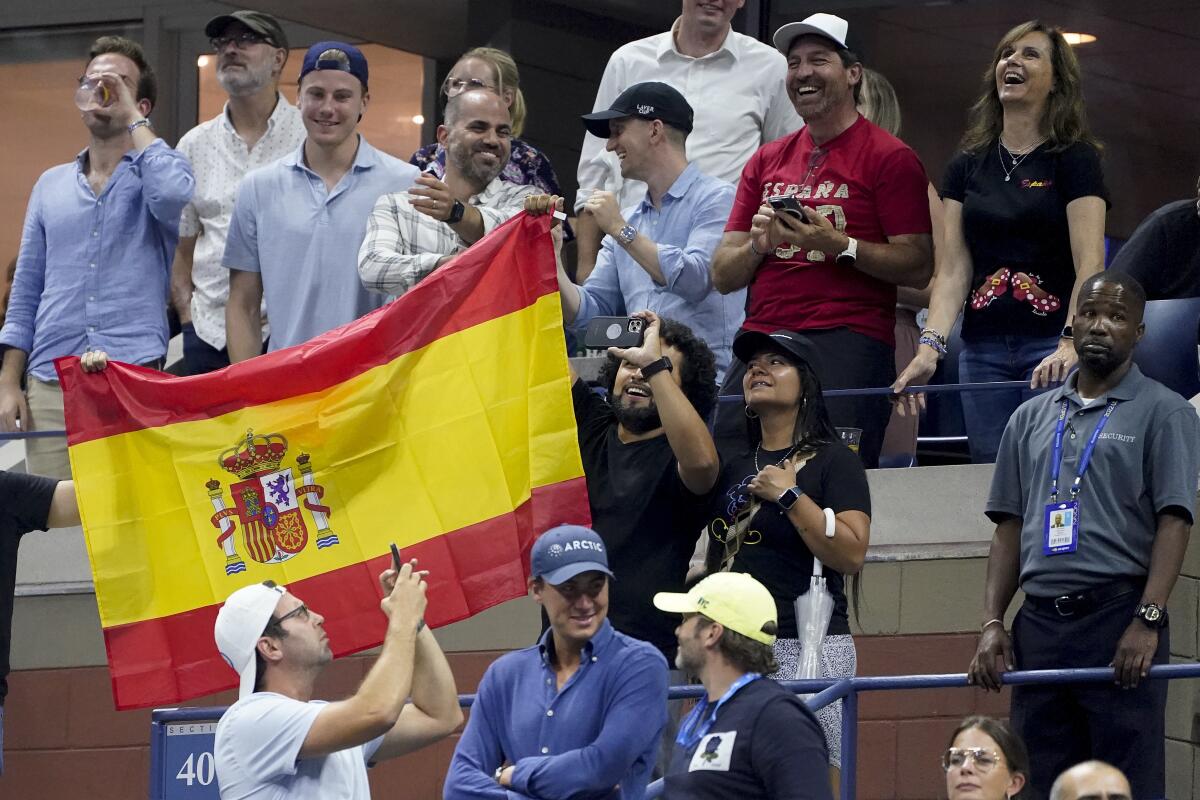 Tennis fans hold up the flag of Spain after Carlos Alcaraz, of Spain, defeating Casper Ruud, of Norway, during the men's singles final of the U.S. Open tennis championships, Sunday, Sept. 11, 2022, in New York. (AP Photo/John Minchillo)