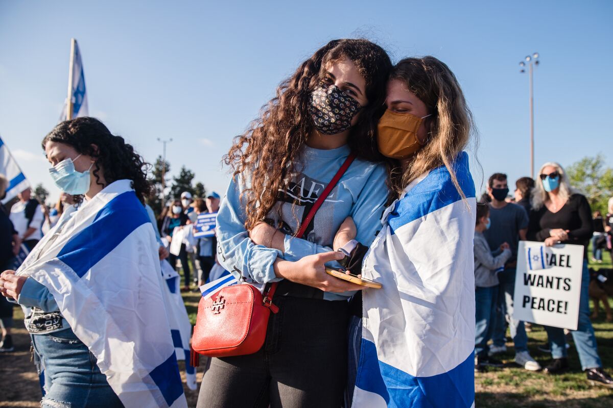Attendees at a pro-Israel rally embrace at the Lawrence Family Jewish Community Center