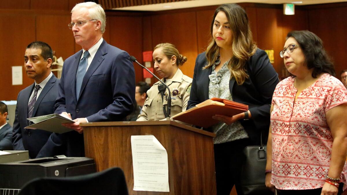 Los Angeles school board member Ref Rodriguez, left, appears with his attorney Daniel V. Nixon, as his cousin Elizabeth Tinajero Melendrez, right, appears with her attorney Amanda Carter for arraignment Tuesday on charges of political campaign money laundering.