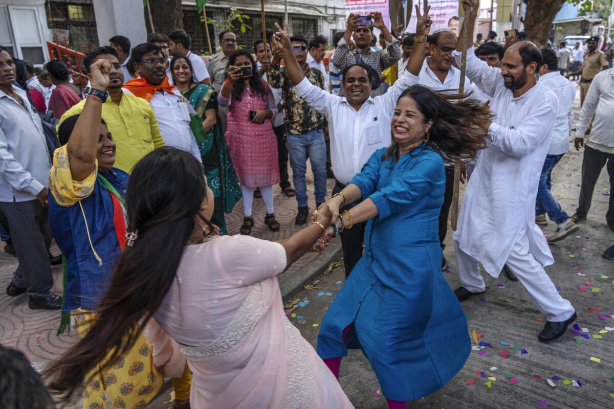 Supporters of the Congress Party celebrate in Mumbai, India.