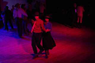 Johnny Reedy, left, and sister Brigid Reedy dance together during the "Midnight Dance" at the National Cowboy Poetry Gathering in Elko, Nevada on Feb. 4, 2023.