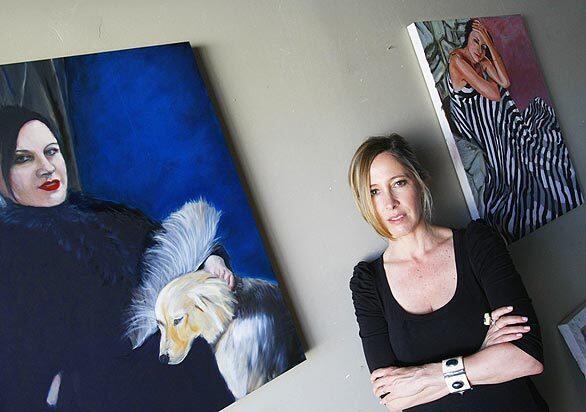 Artist Kimberly Brooks is pictured in her studio in Venice. The painting at left is of Arianne Phillips; at right is one of Andrea Leiberman.