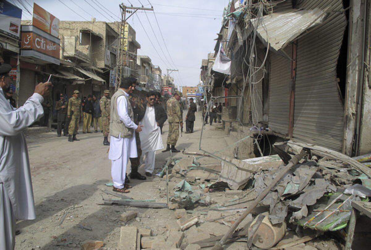 Pakistani security officials check the site of a bomb blast in Dera Ismail Khan.