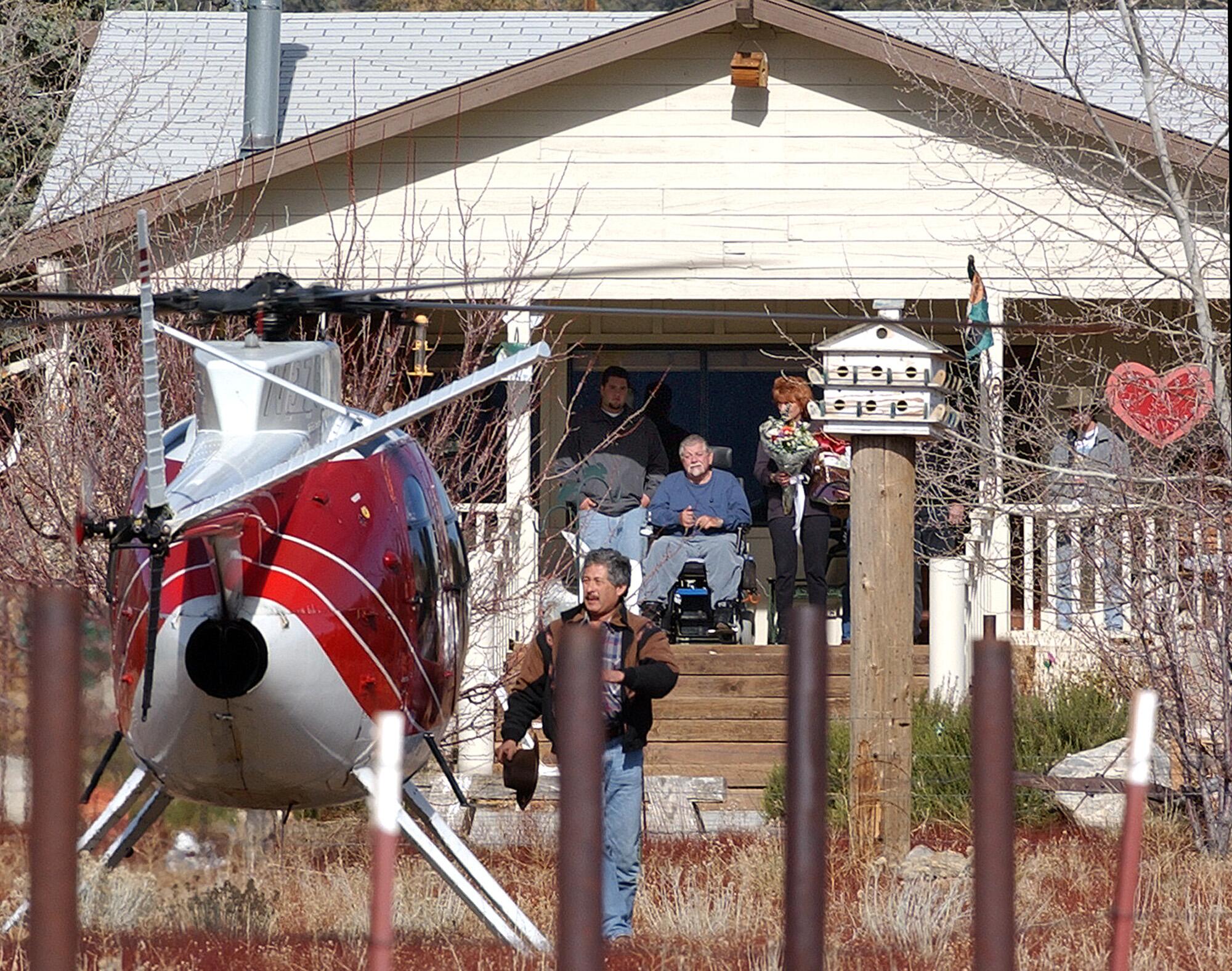 The family of US Special Forces Group Staff Sgt. Brian Cody Prosser watch as a friend, who arrived by helicopter