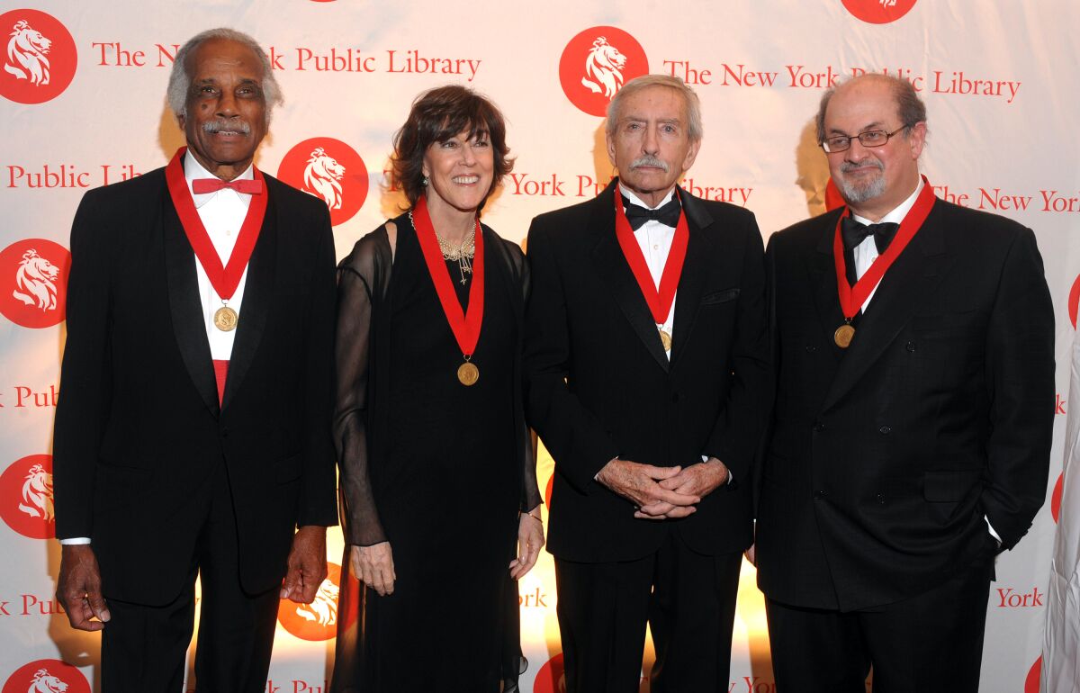 FILE - Honorees, from left, Ashley Bryan, Nora Ephron, Edward Albee and Salman Rushdie pose for a photo at the The New York Public Library's 2008 Library Lions Benefit in New York on Monday, Nov. 3, 2008. Bryan, a prolific children’s book illustrator and storyteller who often retold African folktales he had heard as a child, has died at age 98. The Ashley Bryan Center in coastal Maine says Bryan died Friday, Feb. 4, 2022, at his niece’s home in Texas. (AP Photo/Peter Kramer, File)