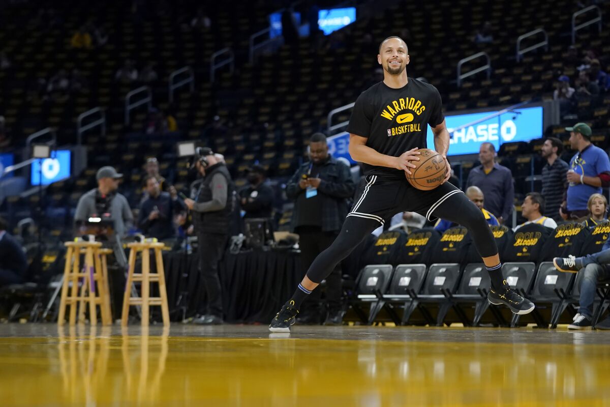 Golden State Warriors guard Stephen Curry warms up before Game 1 of the team's NBA basketball first-round playoff series against the Denver Nuggets in San Francisco, Saturday, April 16, 2022. (AP Photo/Jeff Chiu)