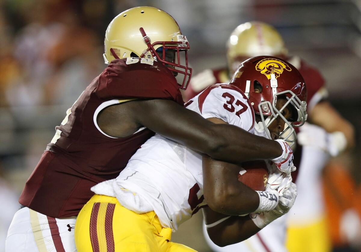USC running back Javorius Allen is wrapped up by Boston College linebacker Steven Daniels during the Trojans' 37-37 loss to the Eagles on Sept. 13.