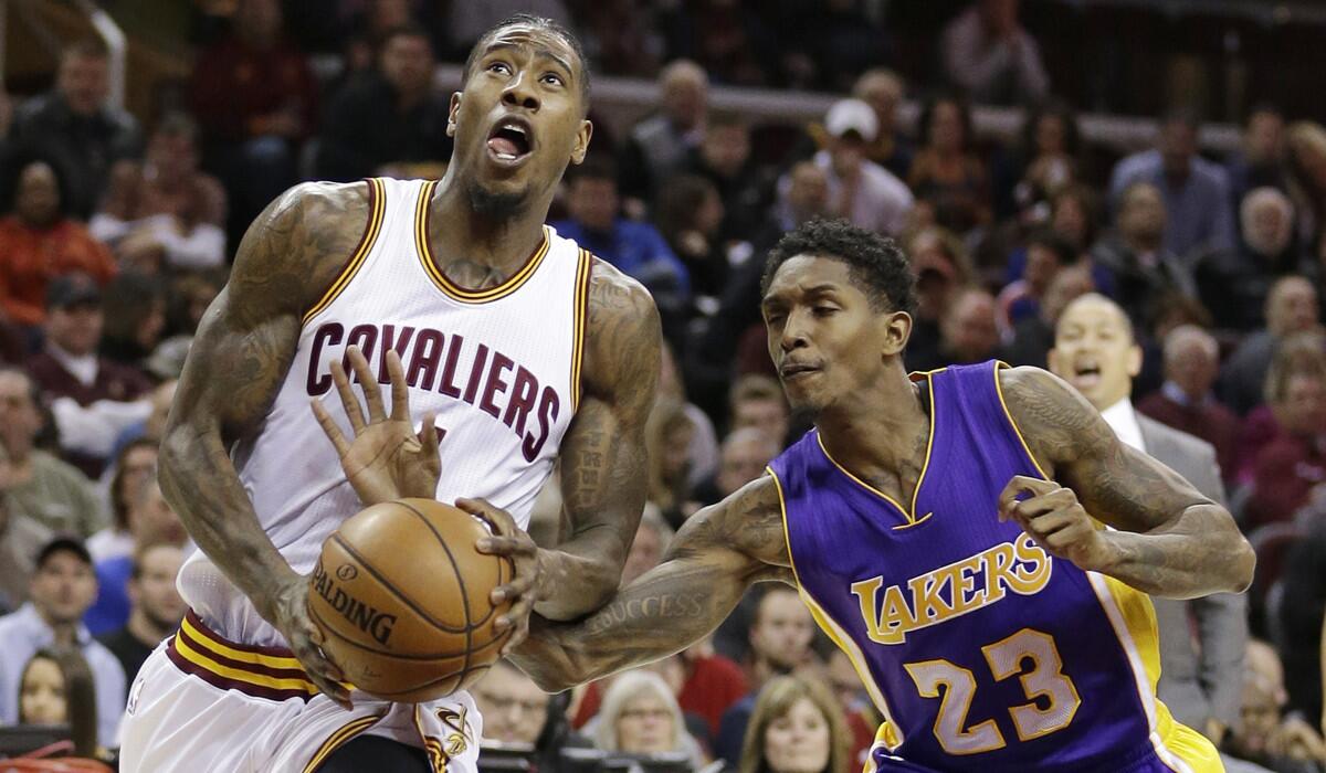 The Cleveland Cavaliers' Iman Shumpert is fouled by Laker Louis Williams in the first half on Saturday.