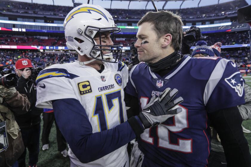 Chargers quarterback Philip Rivers and New England Patriots quarterback Tom Brady meet up after New England beat L.A. 41-28 in the NFL AFC Divisional Playoff at Gillette Stadium.