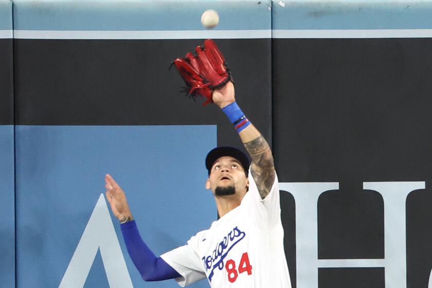 Dodgers center fielder Andy Pages makes a catch at the wall against the Nationals at Dodger Stadium Tuesday.