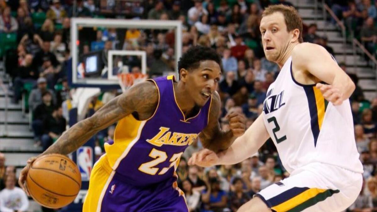 Lakers guard Lou Williams (23) drives to the basket as Jazz forward Joe Ingles (2) defends in the first half on Jan. 26.