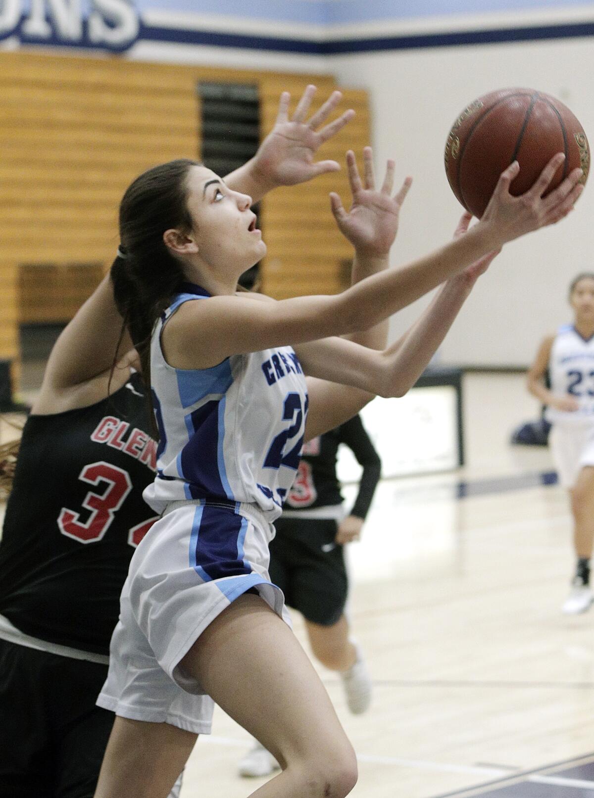 Crescenta Valley's Katrina Minassian drives to shoot after beating Glendale's Melissa Zamora to the basket in a Pacific League girls' basketball game at Crescenta Valley High School on Tuesday, January 7, 2020.