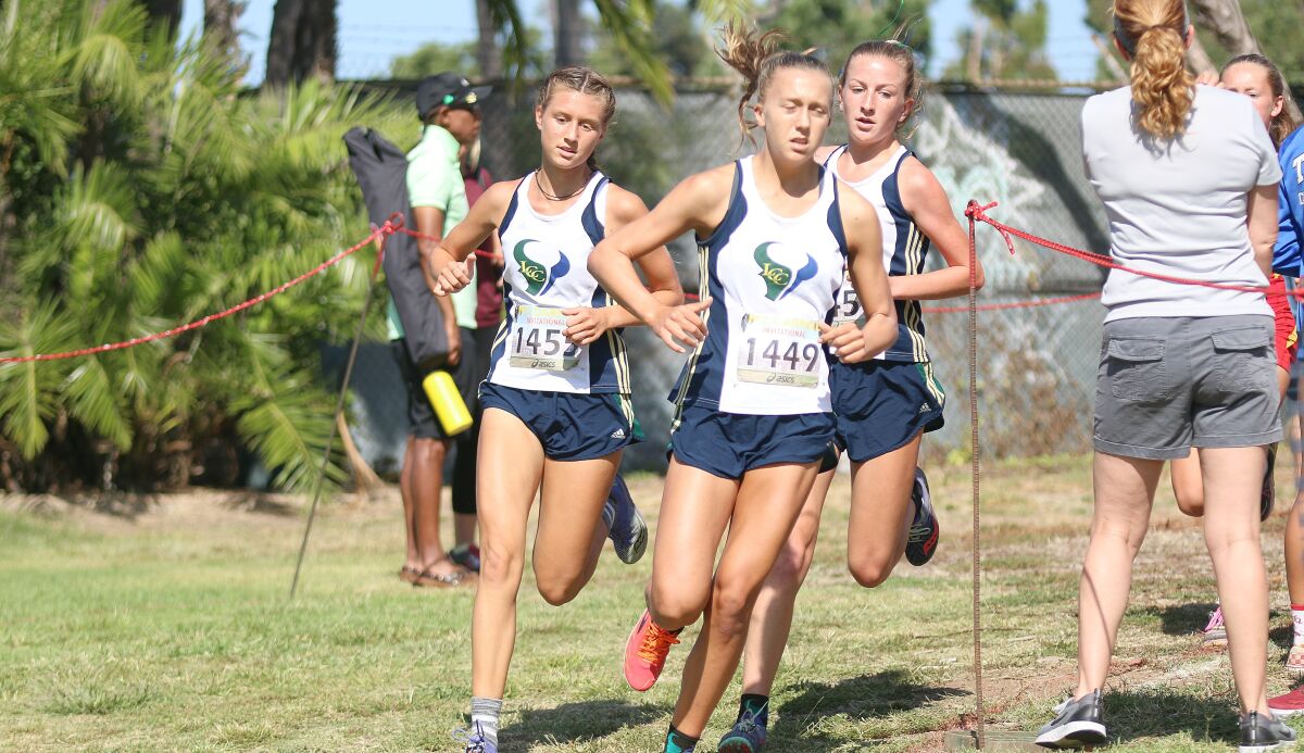 LCC's Kyra Compton (center) with teammates Rebekah Niednagel (left) and Georgia Patyna (right) early in Saturday's race.