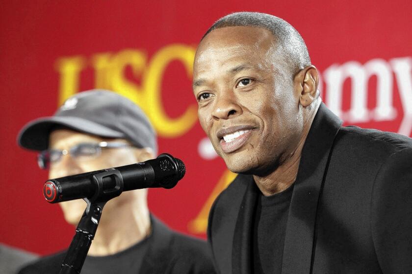 Hip-hop mogul Dr. Dre, right is one of the names behind Beats Music.