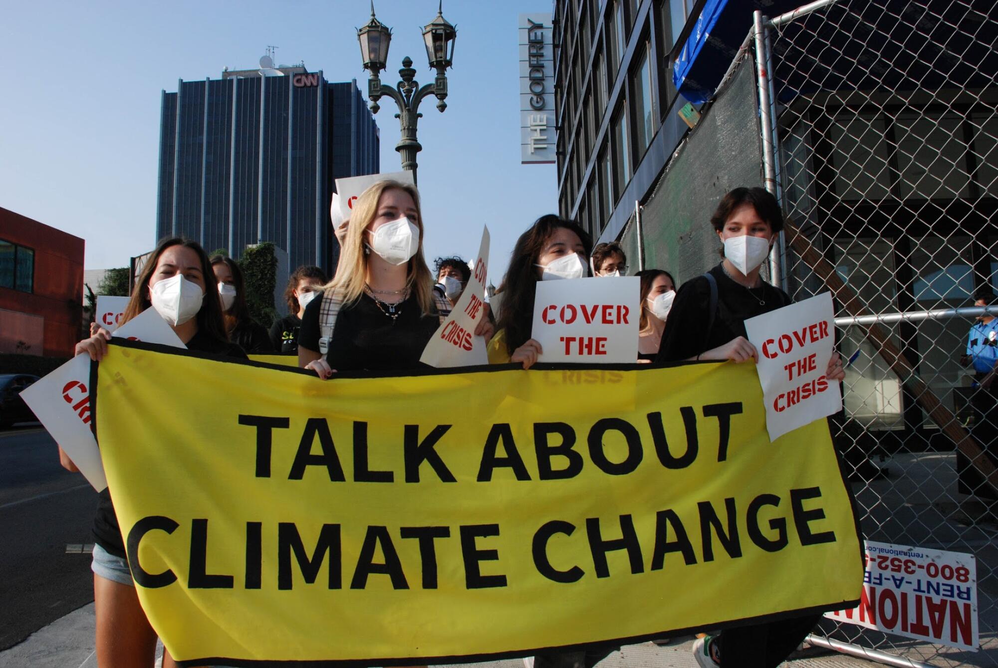 Protesters hold a banner that reads: "Talking about climate change"  