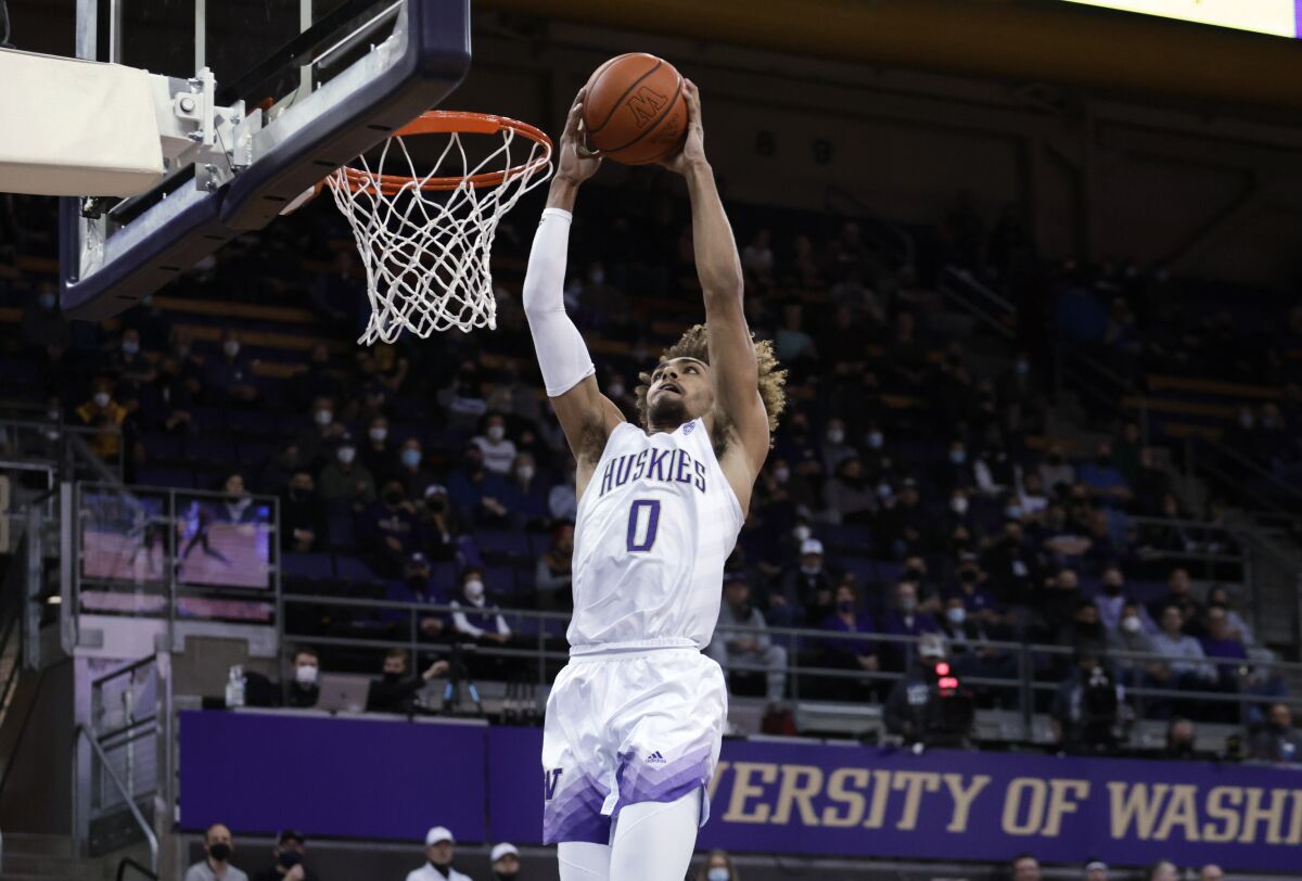 Washington's Emmitt Matthews Jr. goes to the basket for a dunk against Arizona State during the first half of an NCAA college basketball game Thursday, Feb. 10, 2022, in Seattle. (AP Photo/John Froschauer)