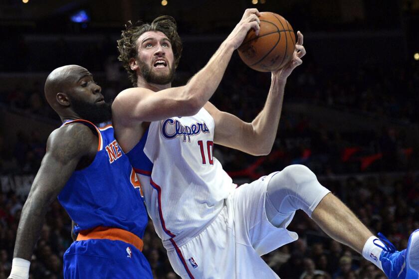 Clippers center Spencer Hawes pulls down a rebound against Knicks forward Quincy Acy in the second half of their game on Wednesday night.