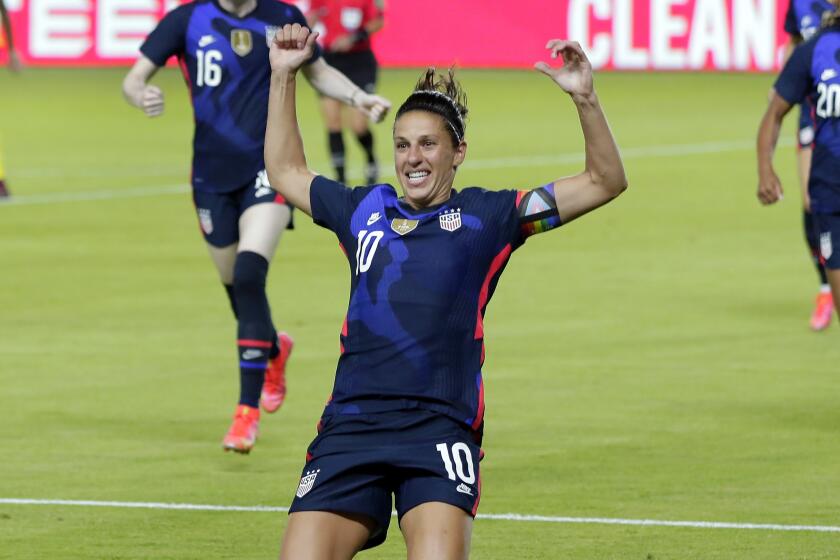 U.S. forward Carli Lloyd (10) slides on the turf after scoring in the first minute against Jamaica.