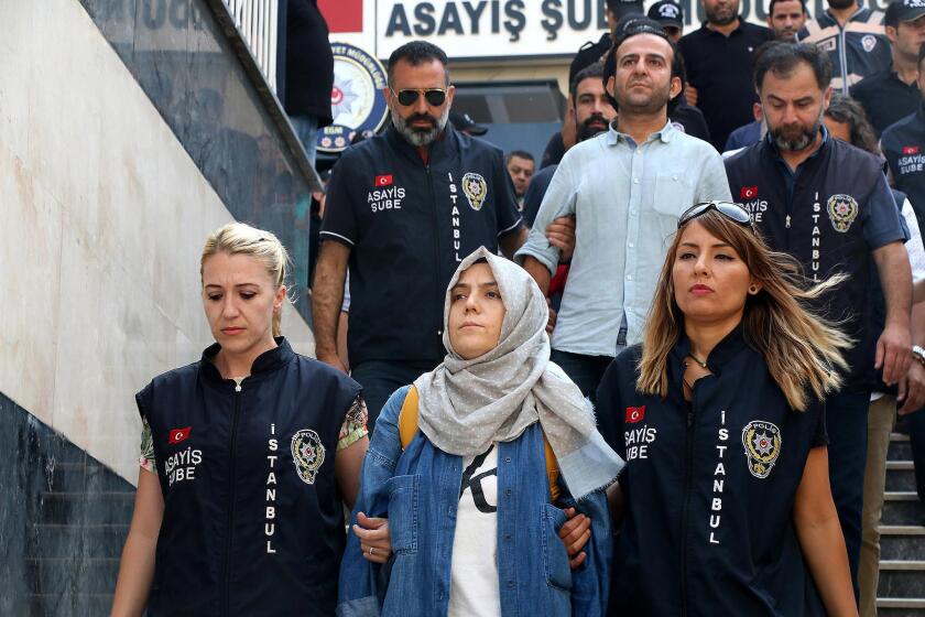 Police escort journalists to court, in Istanbul on Friday. Twenty-one journalists were appearing in court after being detained as part of a sweeping crackdown following Turkey's July 15 failed military coup.