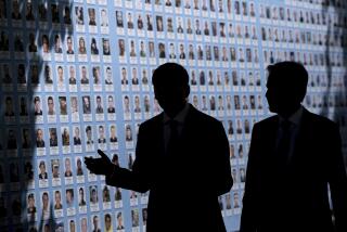 Ukraine's Foreign Minister Dmytro Kuleba, left, and U.S. Secretary of State Antony Blinken visit the Memory Wall of Fallen Defenders of Ukraine outside the Saint Michael's Cathedral, in Kyiv on Wednesday, May 15, 2024. (Brendan Smialowski, Pool Photo via AP)