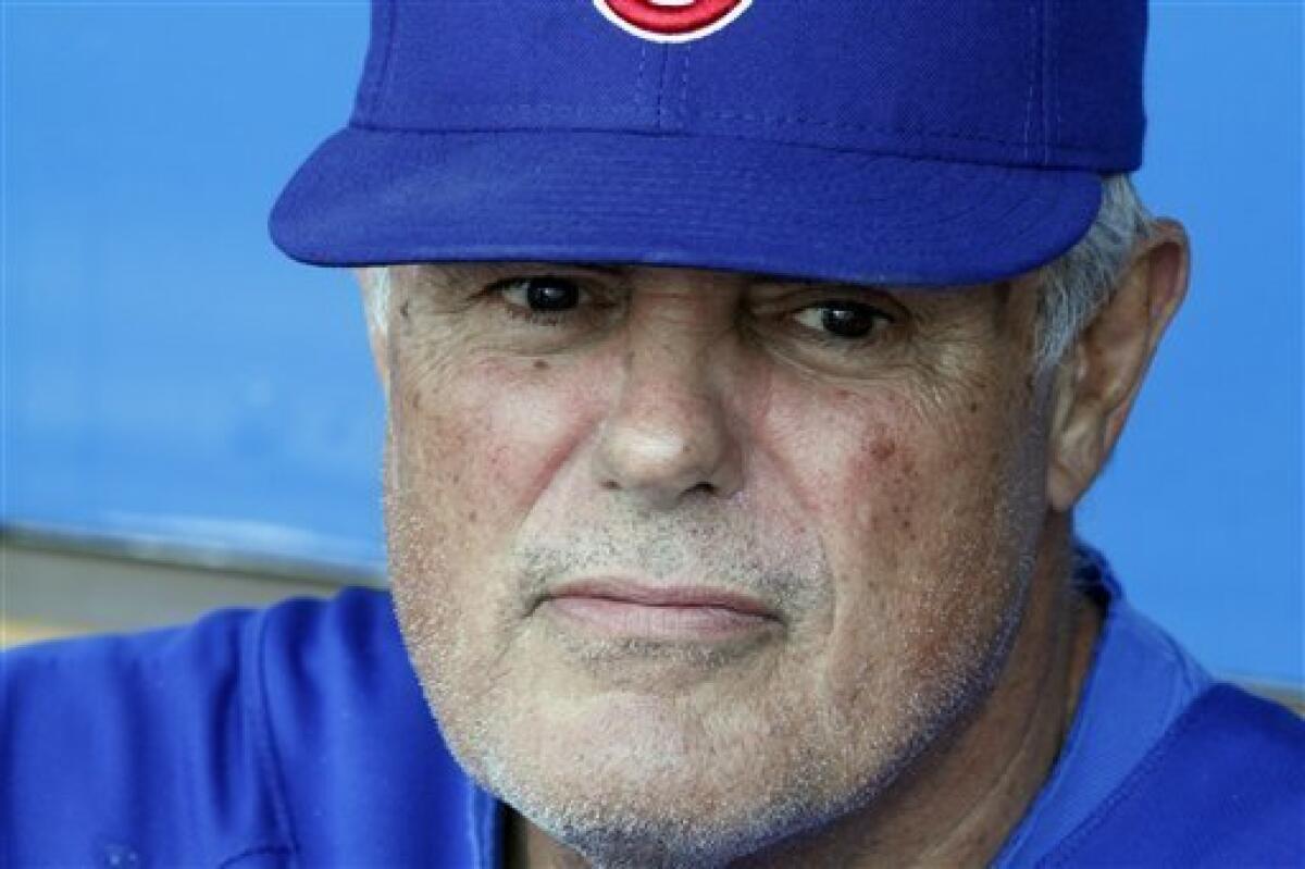 Chicago Cubs manager Lou Piniella tips his hat to the crowd before