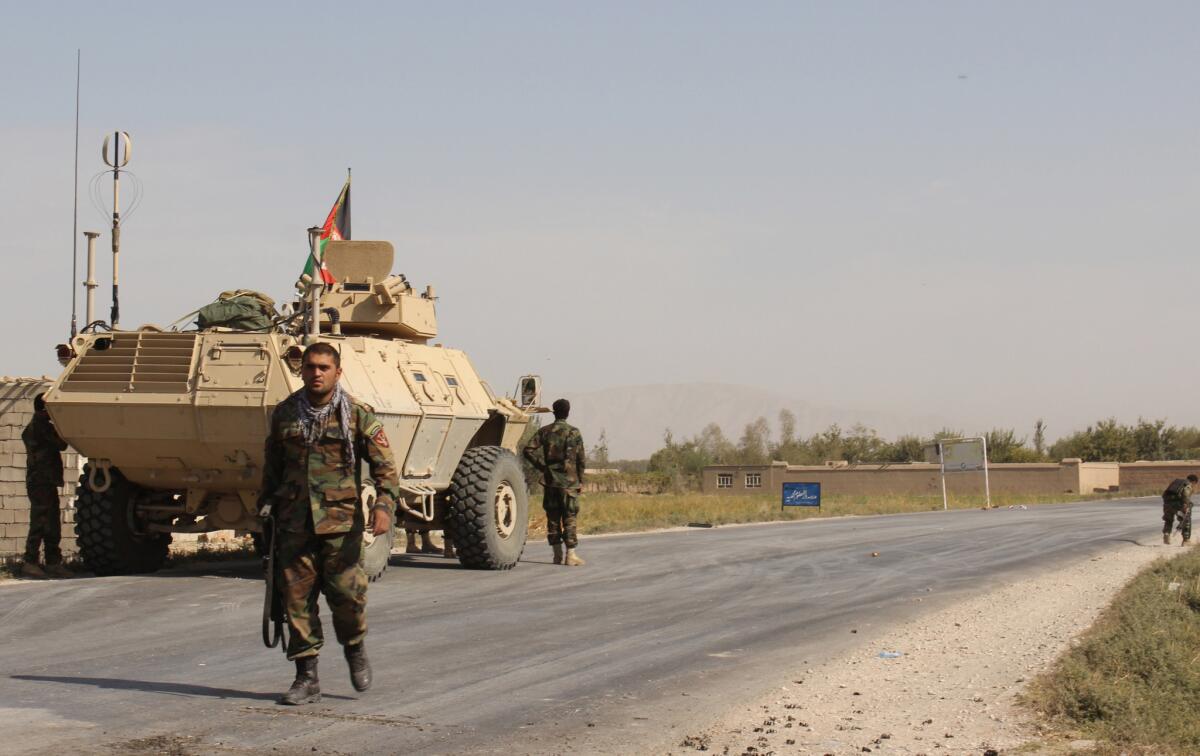 Afghan security forces take their positions during an Oct. 1 clash with Taliban fighters on the highway from Baghlan to Kunduz city, north of Kabul.