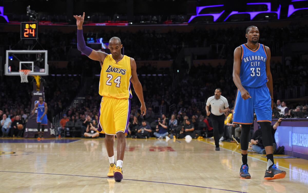 Lakers forward Kobe Bryant, left, reacts after scoring against the Thunder during the second half of a game on Jan. 8.