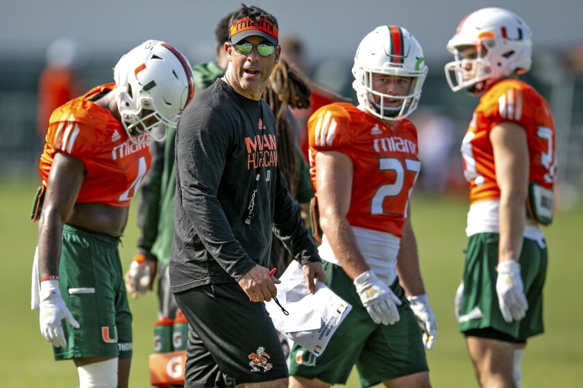 University of Miami offensive coordinator Dan Enos watches over the offense during an NCAA college football practice at the University of Miami Greentree Practice Field in Coral Gables, Fla., Monday, July 29, 2019. (Al Diaz/Miami Herald via AP)