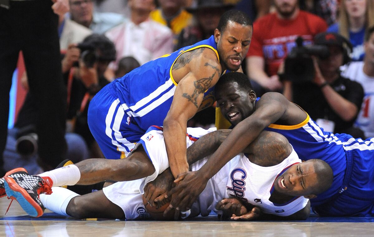 Jamal Crawford is forced into a jump ball by Warriors Andre Iguodala, left, and Draymond Green in Game 7 of the NBA Western Conference playoffs last season.