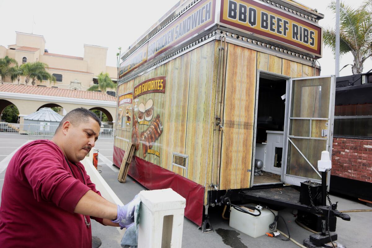 Pascual Aguirre helps set up a food booth for the HomeGrownFun at the Del Mar Fairgrounds on Thursday. 