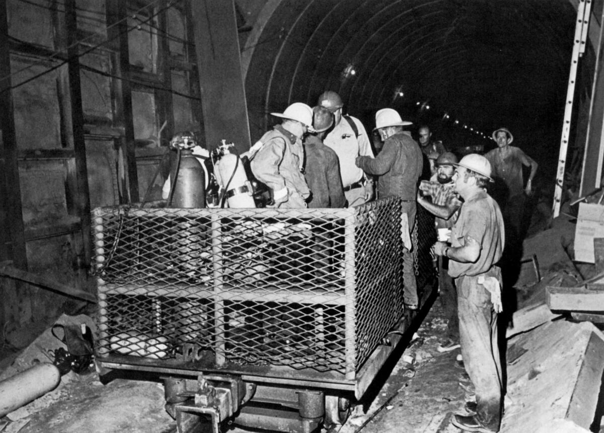 June 24, 1971: Workers and firemen at the bottom of the Gate Shaft prepare to search for victims in tunnel.