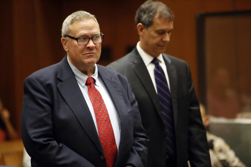 Former Bell Mayor George Cole, left, during his sentencing Wednesday in Los Angeles Superior Court.